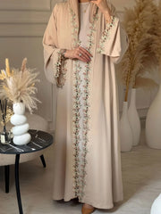 Elegant beige abaya from Dubai for Muslim women – Designed with a piece of multicolored embroidery in modest Islamic fashion