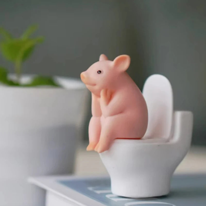Cartoon pig desk ornament, pig sitting on the toilet, miniature pig figurine, creative toy, children's gift, desk decoration