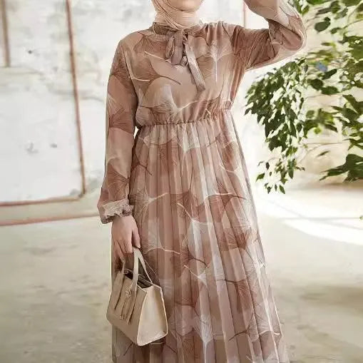Abaya – a custom Muslim dress, leaf print, loose fit, long sleeves, suitable for Dubai parties, made of pleated chiffon.