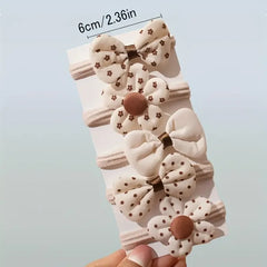 Set of 10 sporty hair accessories for girls with a floral design and a bow tie, in light beige color.
