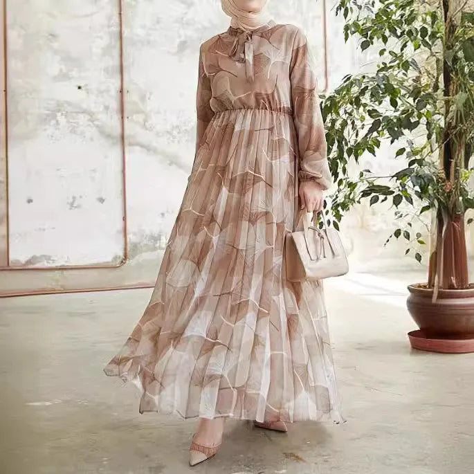 Abaya – a custom Muslim dress, leaf print, loose fit, long sleeves, suitable for Dubai parties, made of pleated chiffon.