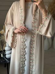 Elegant beige abaya from Dubai for Muslim women – Designed with a piece of multicolored embroidery in modest Islamic fashion