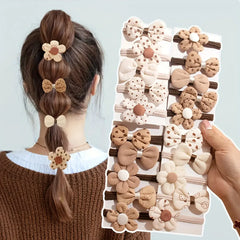 Set of 10 sporty hair accessories for girls with a floral design and a bow tie, in light beige color.