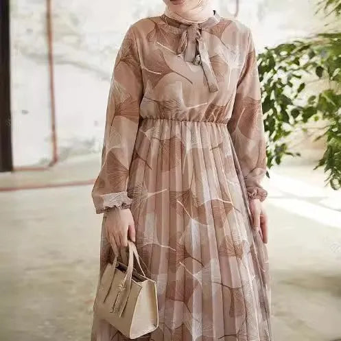 Abaya – a custom Muslim dress, leaf print, loose fit, long sleeves, suitable for Dubai parties, made of pleated chiffon.